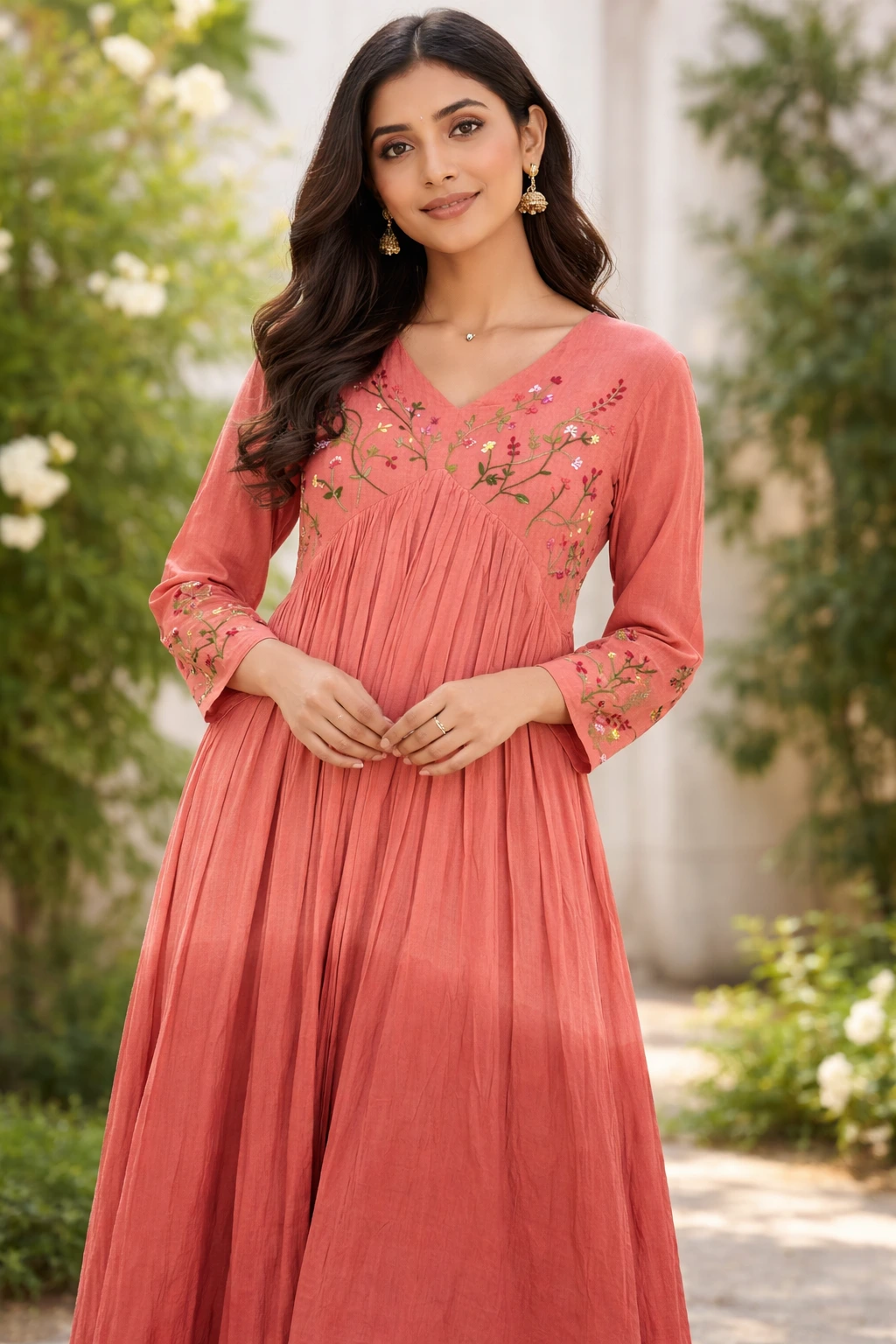 Pure mul cotton 2-piece ethnic set in a soft coral hue, featuring floral embroidery on the bodice and sleeves, with a flowing, pleated design.