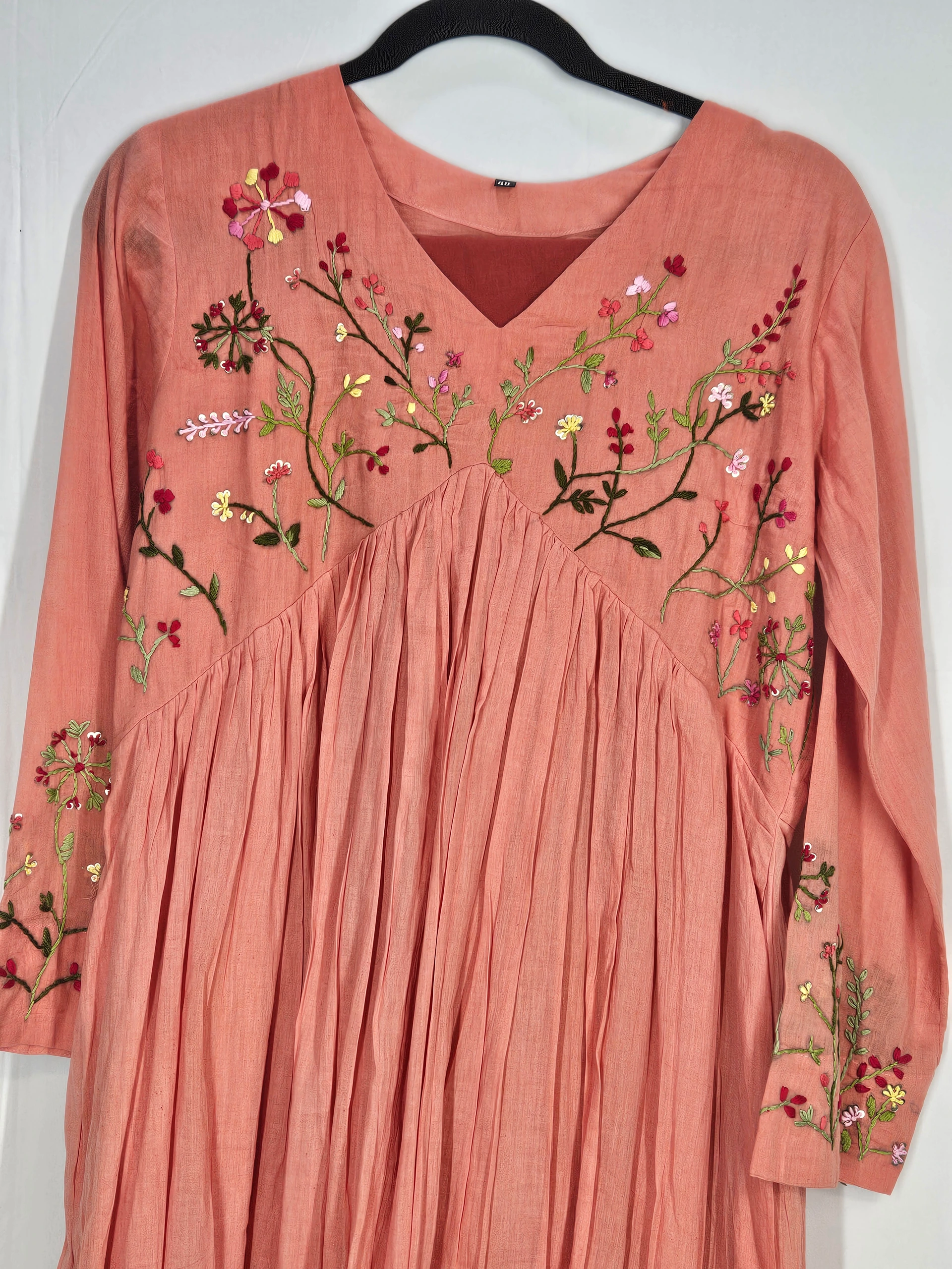 Pure mul cotton 2-piece ethnic set in peach, featuring intricate floral embroidery on the bodice and sleeves, with a pleated design for timeless elegance.