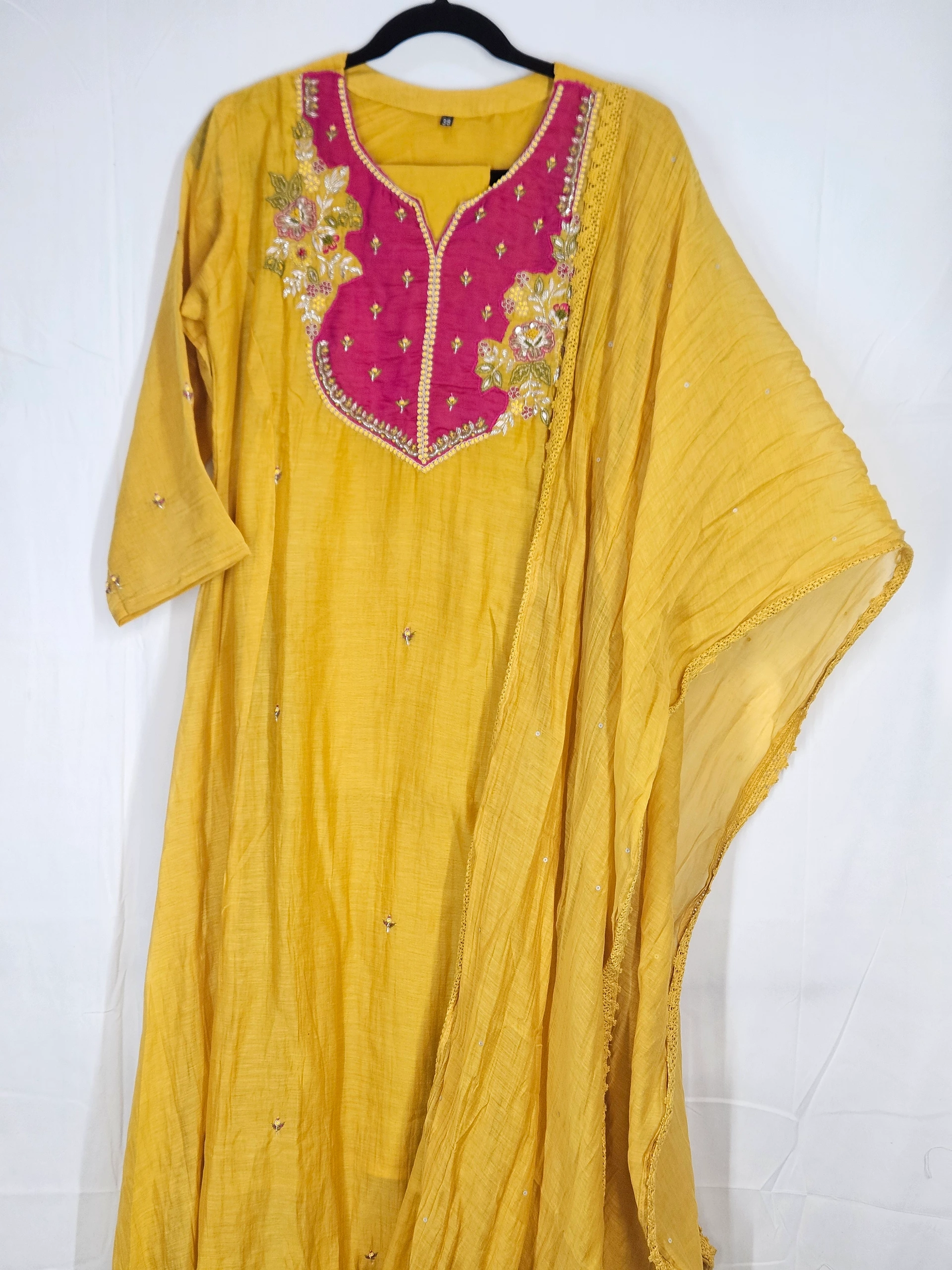 Mustard yellow Chanderi silk suit with intricate embroidery, featuring a vibrant pink yoke and delicate embellishments, perfect for festive and wedding wear.