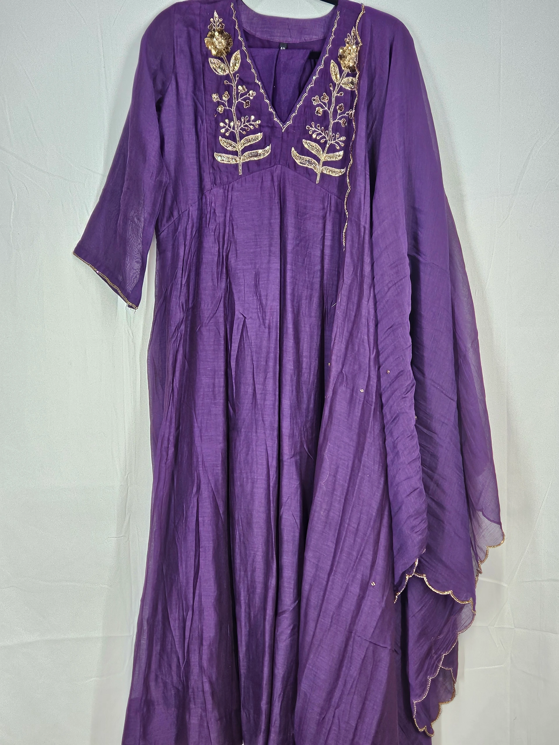 Royal purple Mul Chanderi Anarkali dress with intricate gold embroidery on the bodice, paired with a flowy gold-trimmed dupatta.