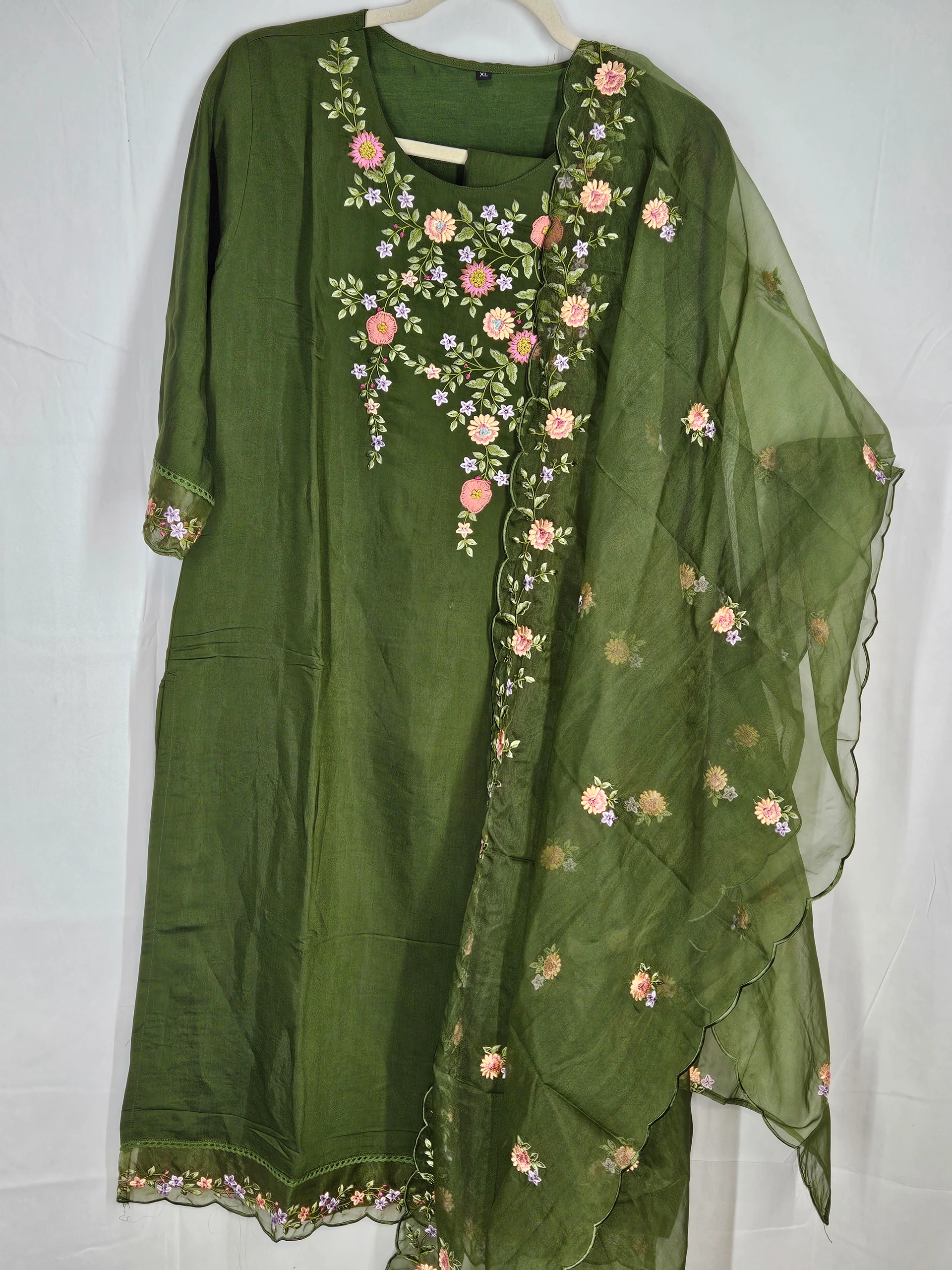 Green pure muslin ethnic lehenga dress with floral embroidery, featuring a matching dupatta adorned with delicate floral patterns. Perfect for weddings and festivals.