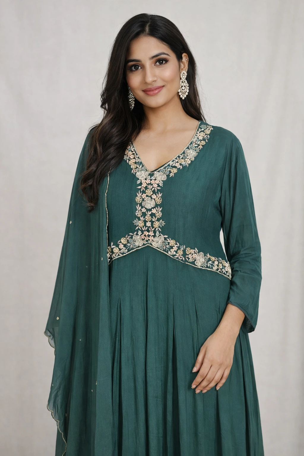 Elegant pure chinon Anarkali gown in deep green with intricate floral embroidery on the neckline and waist, paired with a matching dupatta.