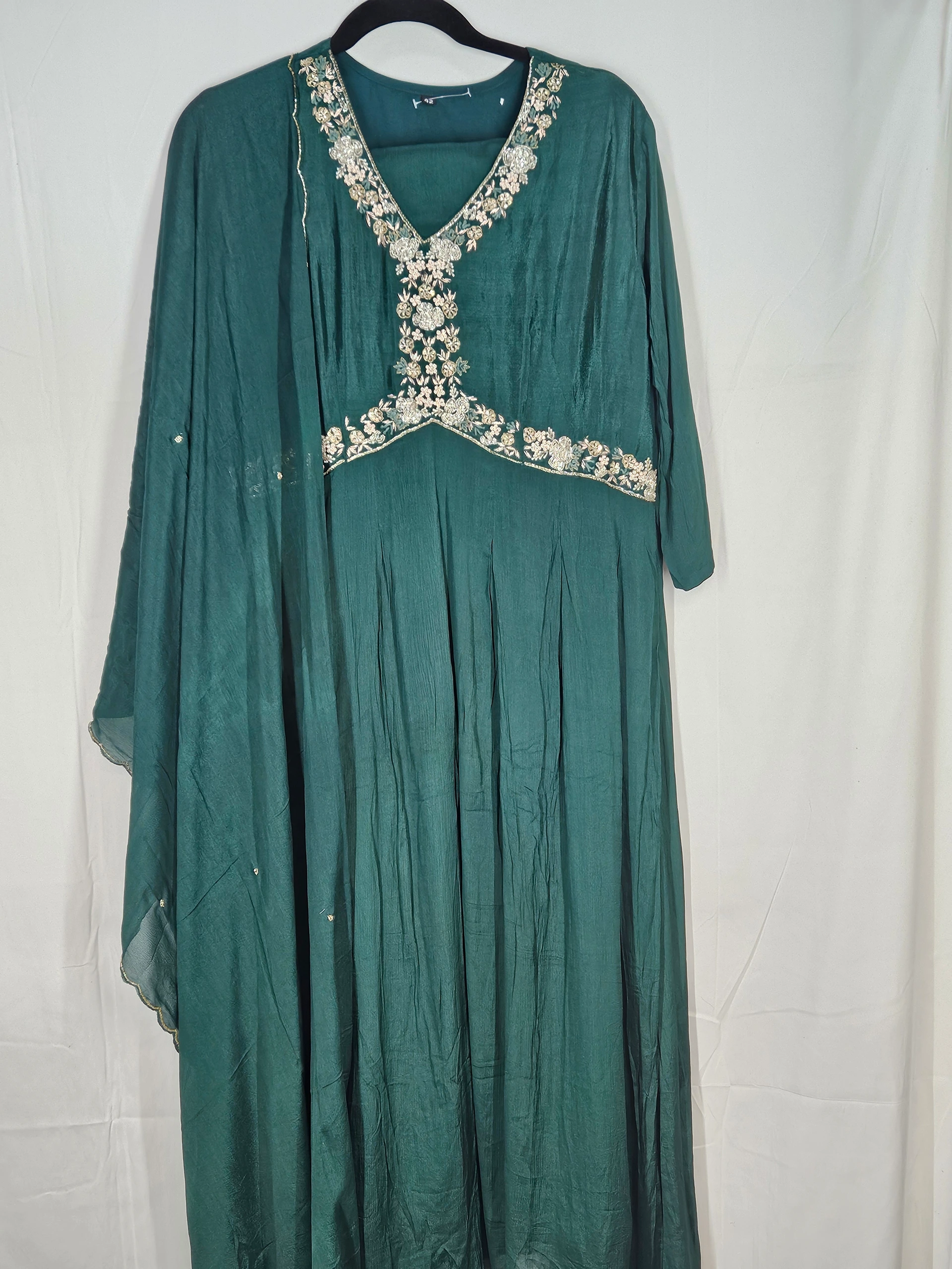 Elegant pure chinon Anarkali gown in deep green with intricate floral embroidery on the neckline, perfect for weddings and festivals.