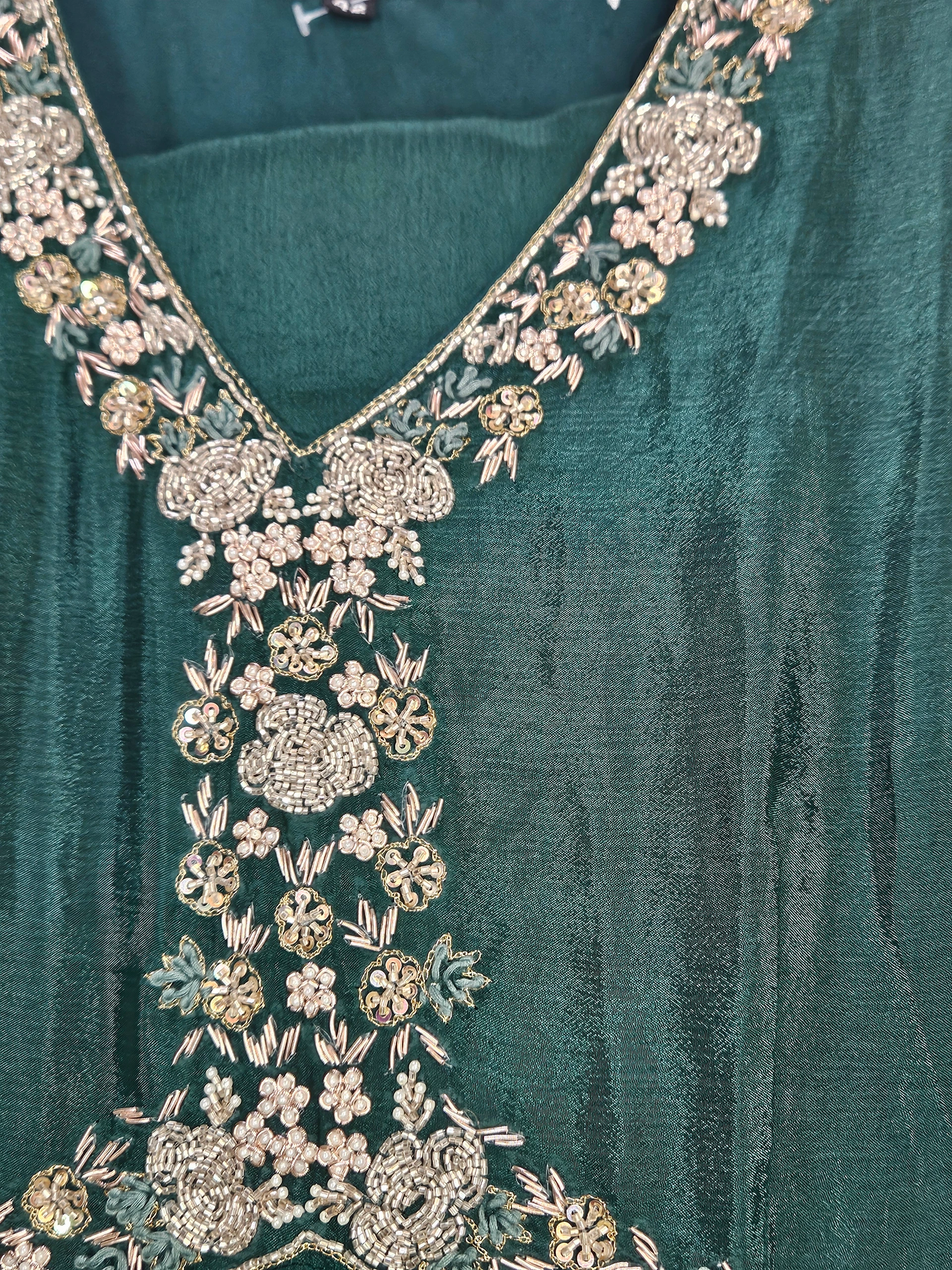 Elegant pure chinon Anarkali gown in deep green with intricate silver floral embroidery on the neckline and bodice, perfect for weddings and festivals.