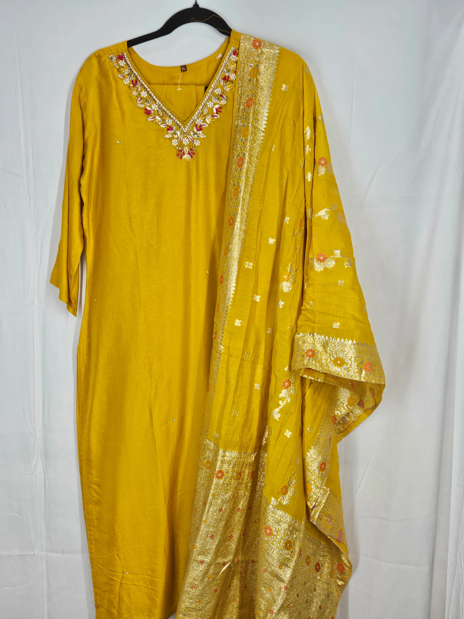 Yellow Pure Dola Silk dress with intricate gold embroidery on the neckline and a matching dupatta adorned with golden patterns, ideal for weddings and festive occasions.