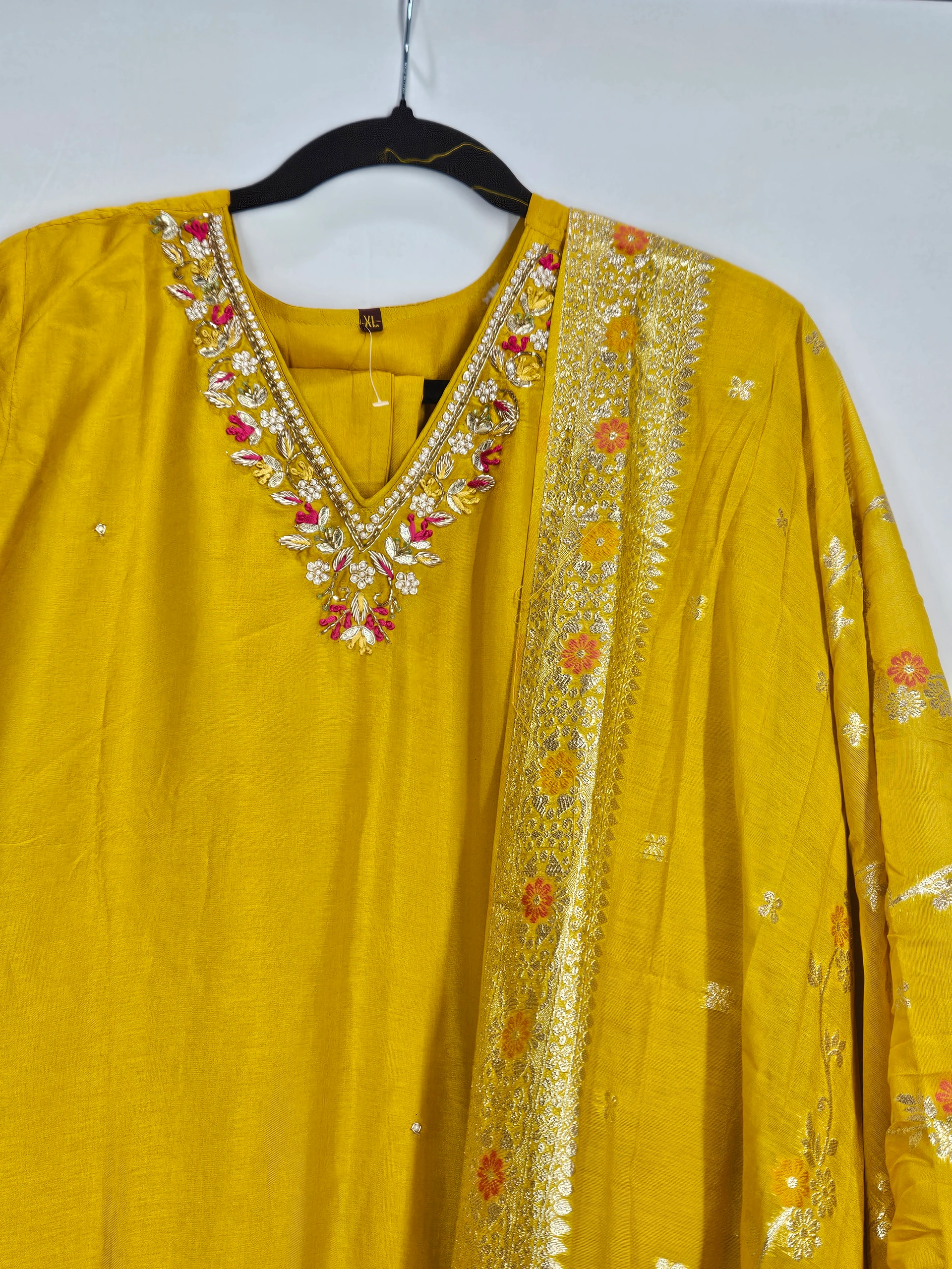 Yellow pure Dola silk dress with intricate floral embroidery on the neckline and dupatta, perfect for weddings and festive occasions.