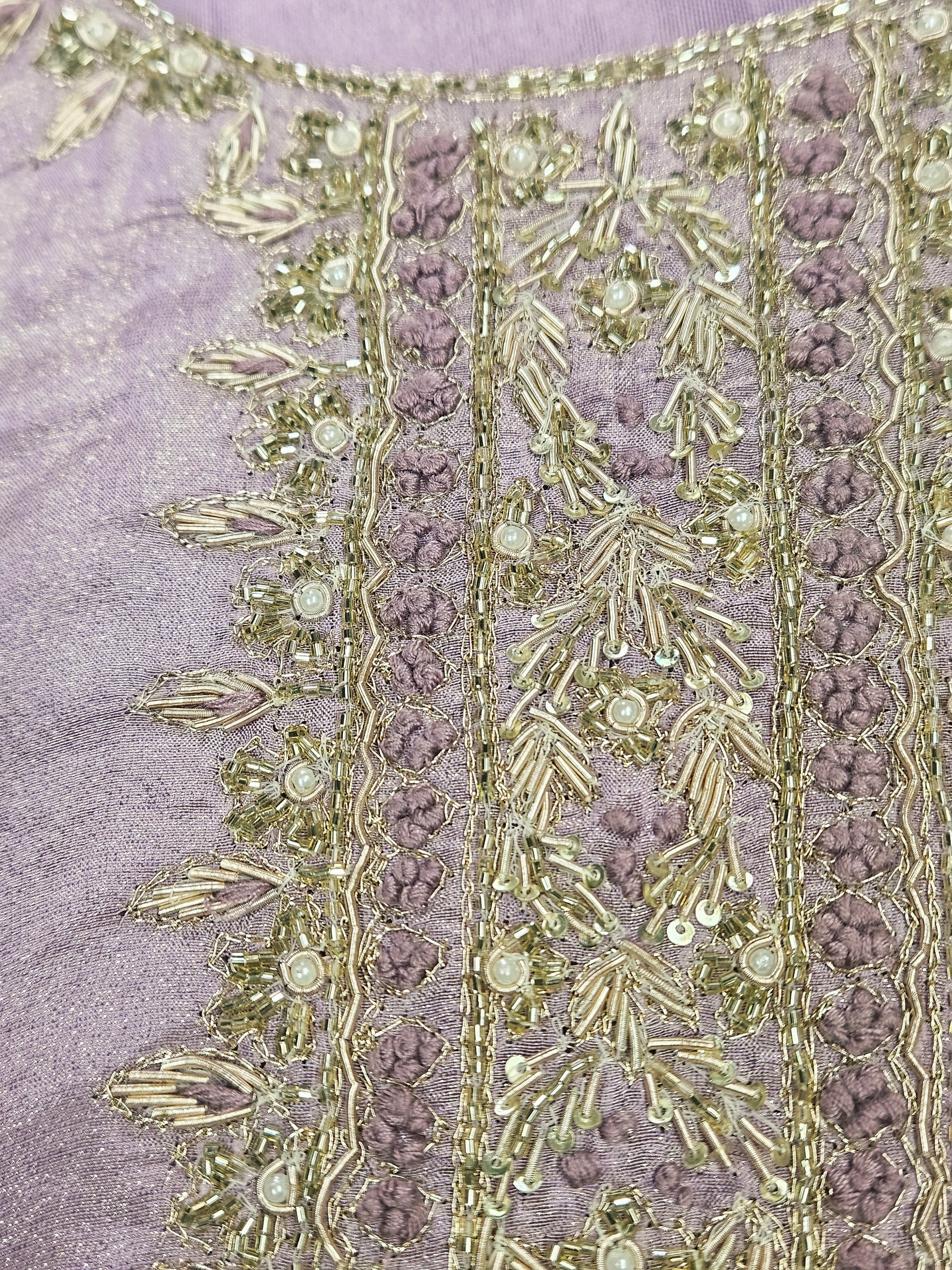 Luxurious pure tissue silk dress in soft lavender, adorned with intricate gold embroidery, pearl detailing, and floral patterns, perfect for weddings and festive celebrations.