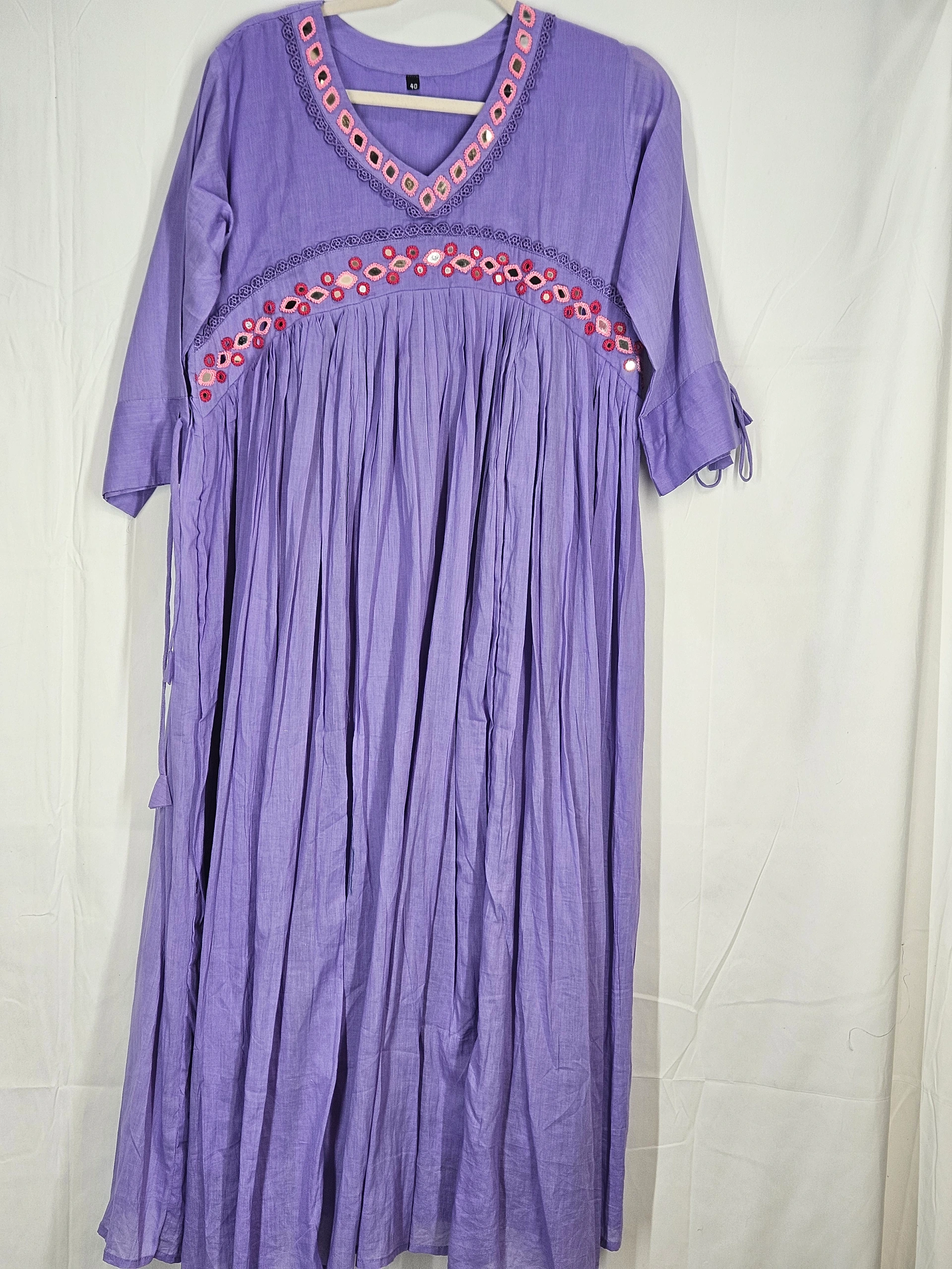 Handcrafted pure mul cotton frock in lavender with intricate embroidery on the yoke, featuring a V-neckline and three-quarter sleeves.