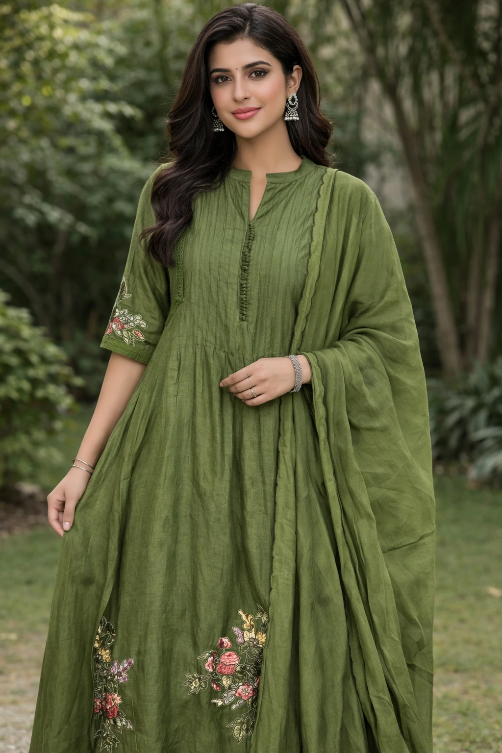 Pure Mul Chanderi silk suit in olive green with floral embroidery on the hem, featuring a pleated kurta, matching dupatta, and three-quarter sleeves.