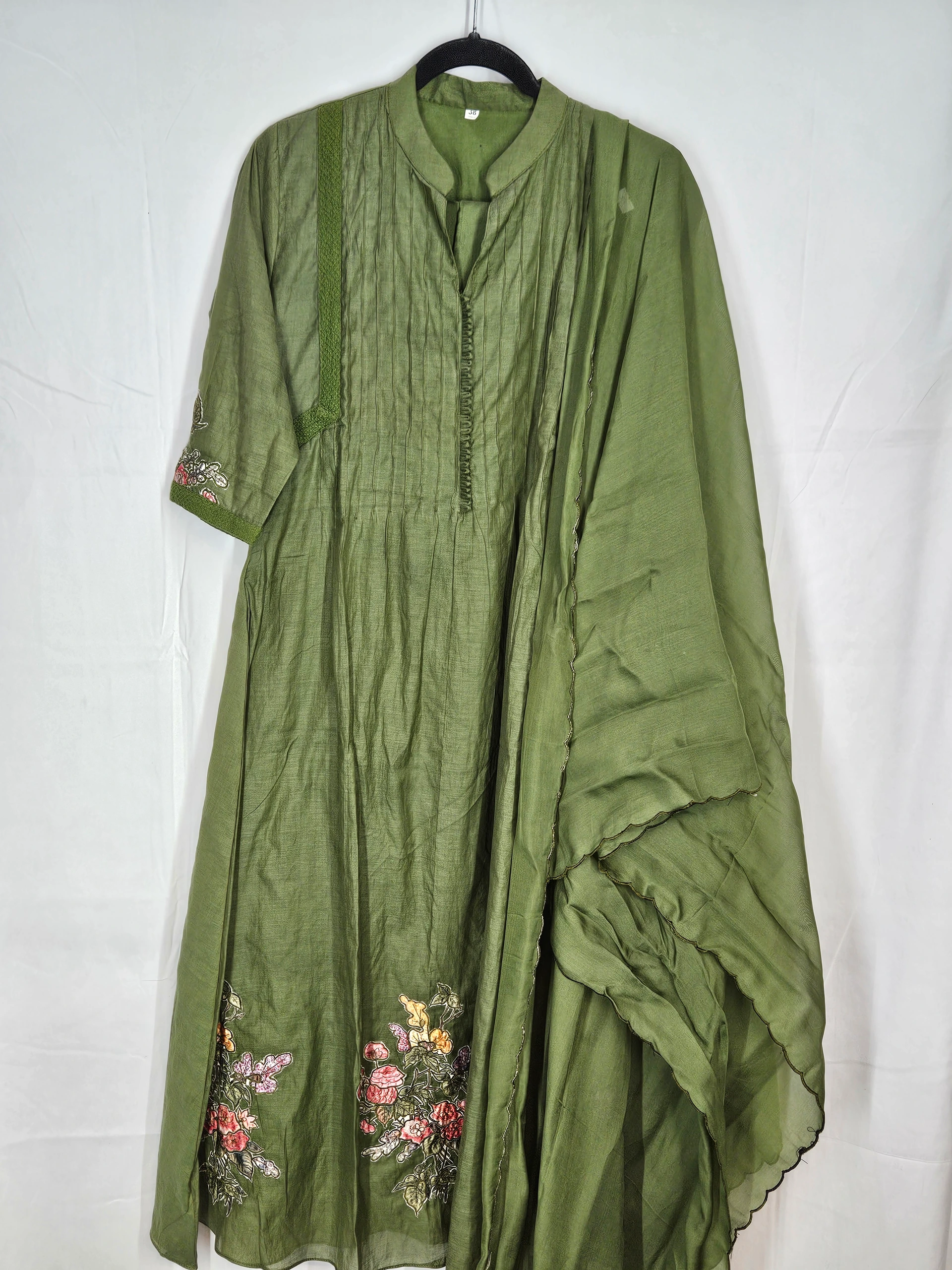 Pure Mul Chanderi silk suit in olive green with floral embroidery on the hem, featuring a pleated kurta, matching dupatta, and churidar.