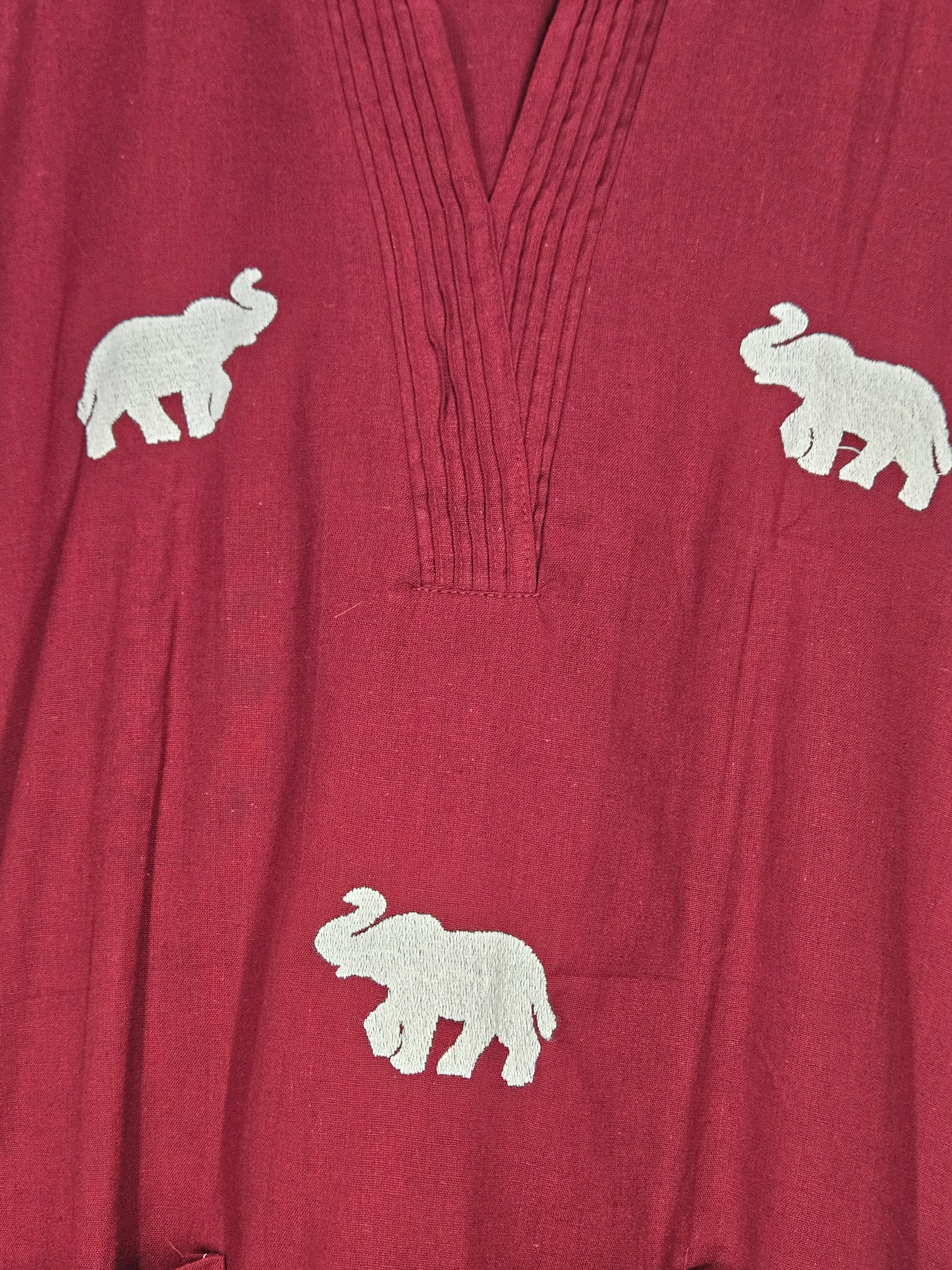 Red pure mul cotton frock featuring white elephant embroidery and delicate pleated detailing on the neckline.