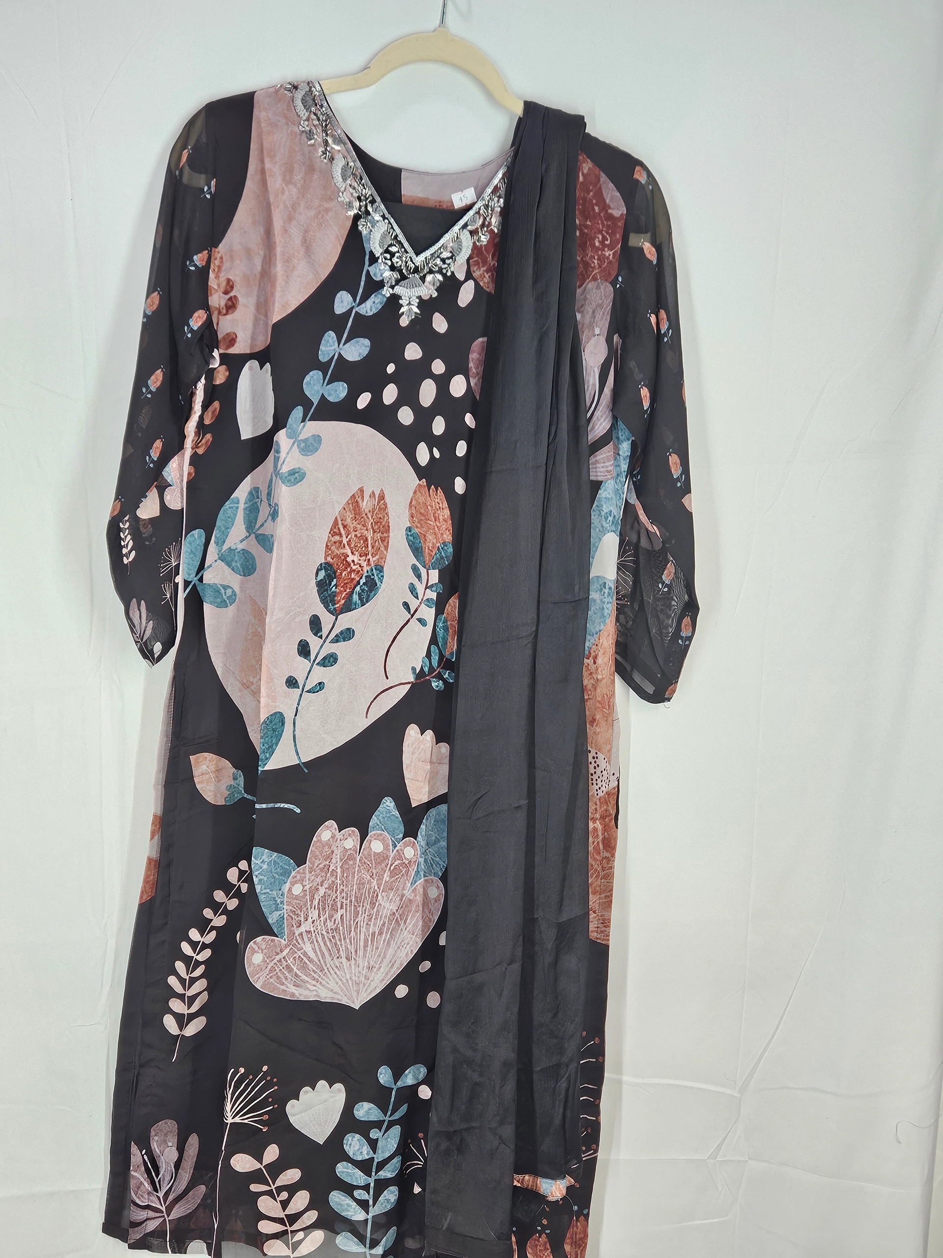 Elegant pure georgette ethnic dress in black with floral prints, featuring a silver embellished neckline and matching dupatta, ideal for weddings and festivities.