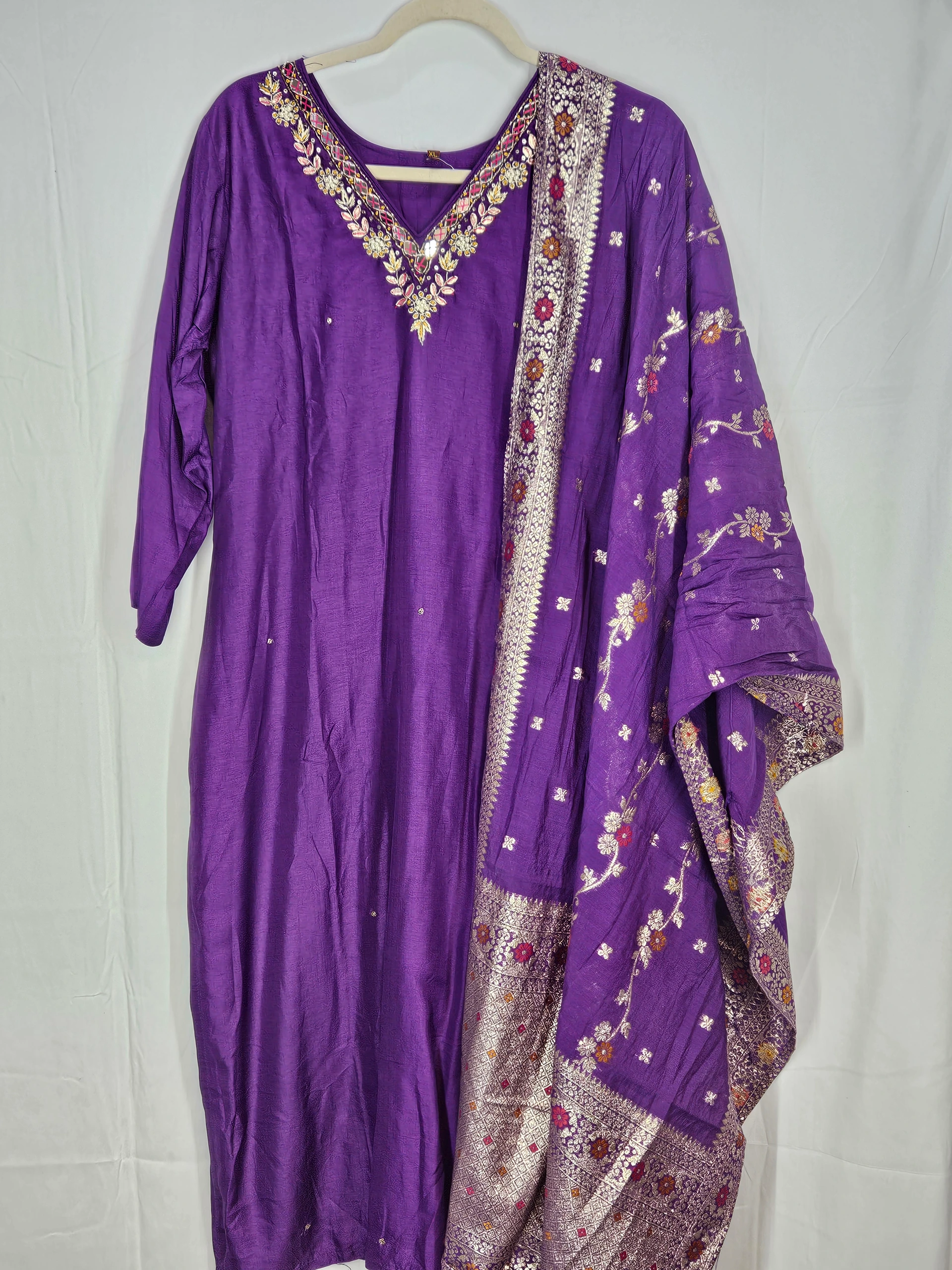 Purple Pure Dola Silk dress with intricate floral embroidery on the neckline, paired with a matching embroidered dupatta featuring traditional Indian patterns.