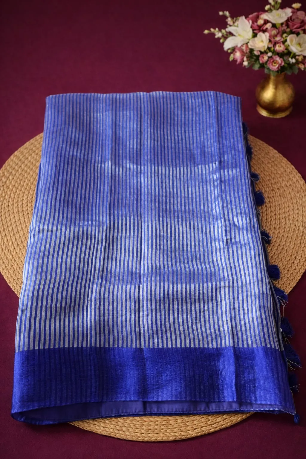 Exquisite blue Banarasi Kora Tissue Silk Saree with silver stripes, featuring a rich blue border, displayed elegantly.