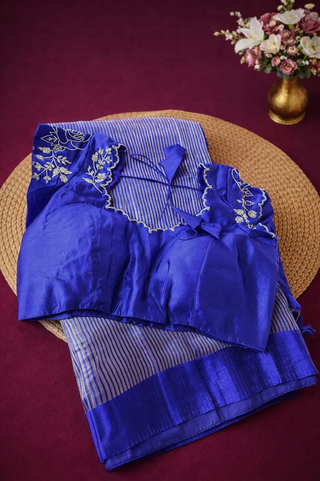 Pure Banarasi Kora tissue silk saree in royal blue with silver zari stripes, paired with an embroidered blouse.