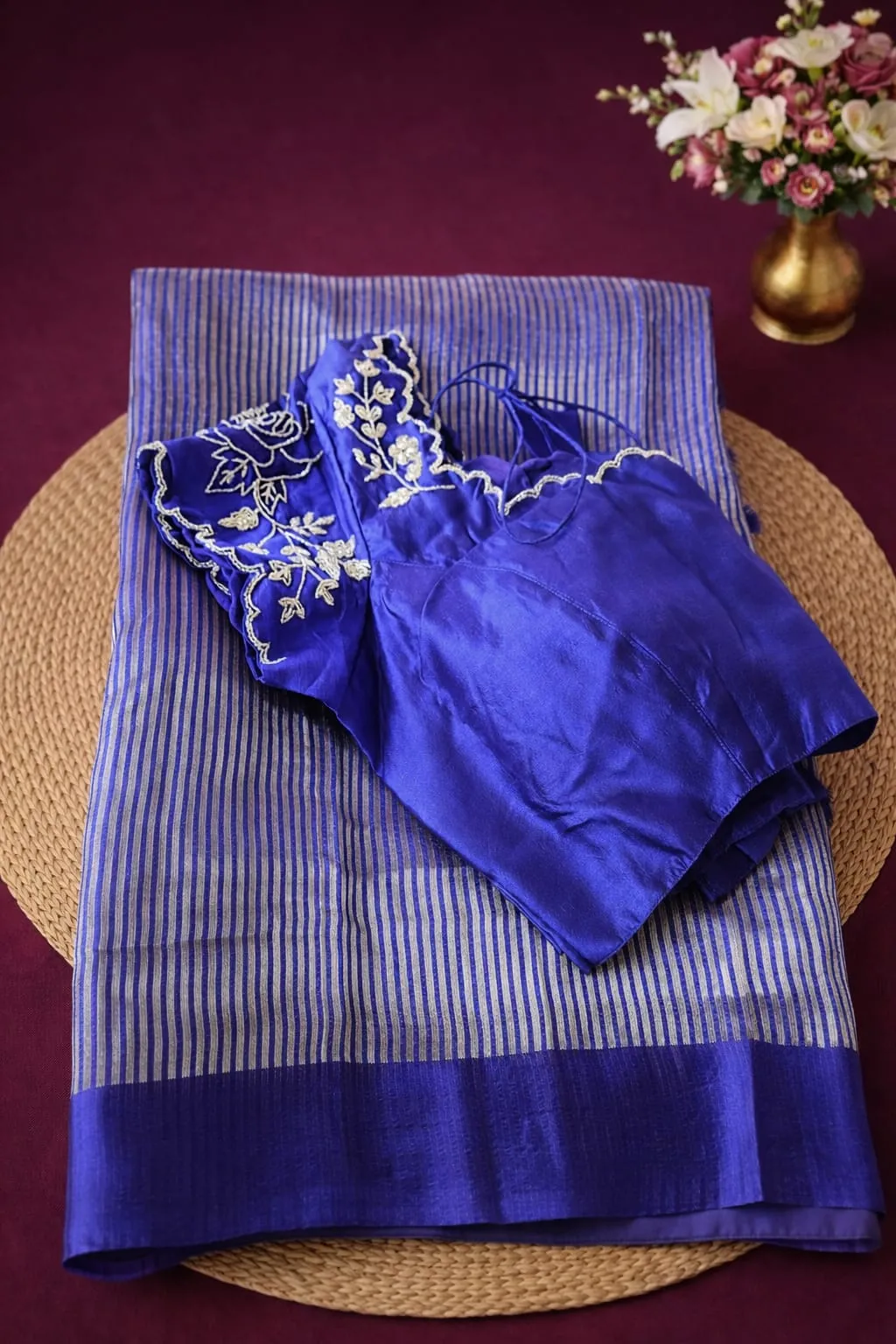 Pure Banarasi Kora tissue silk saree in royal blue with silver stripes, paired with an embroidered blue blouse.