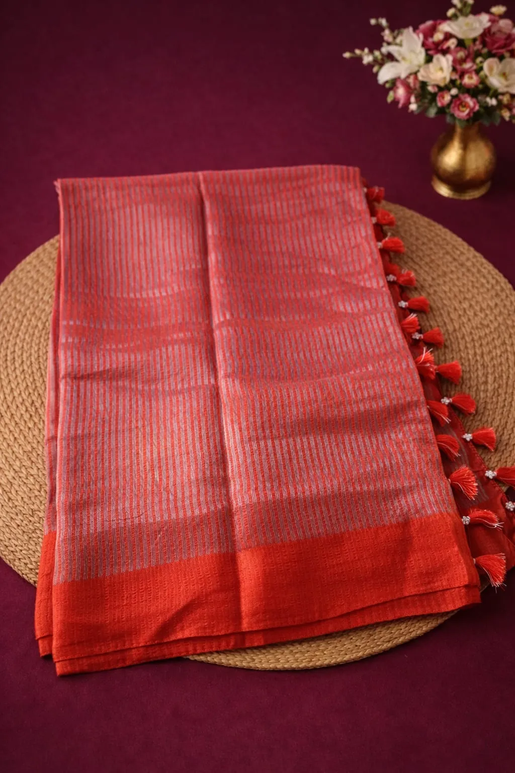 Pure Banarasi silk tissue saree in vibrant red with intricate silver zari stripes, perfect for weddings and festivals.