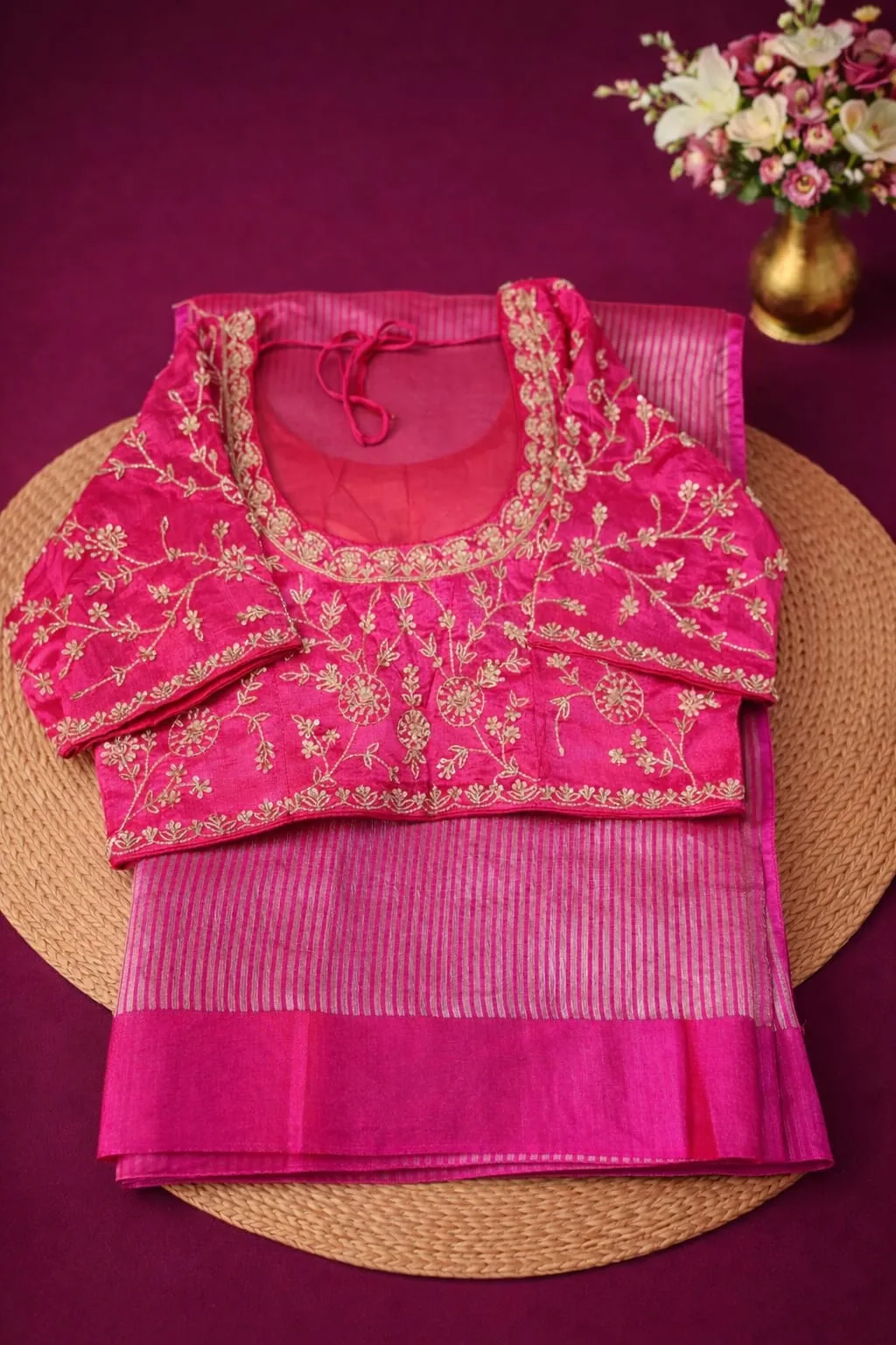 Pure Banarasi Kora tissue silk saree in vibrant pink with gold zari stripes, paired with an embroidered pink blouse.