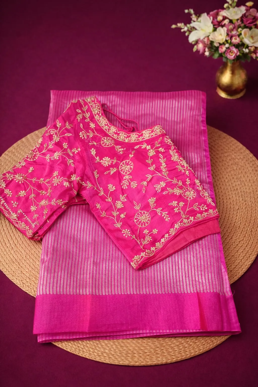 Elegant pink Banarasi Kora tissue silk saree with gold zari embroidery, paired with matching embroidered blouse, ideal for weddings.
