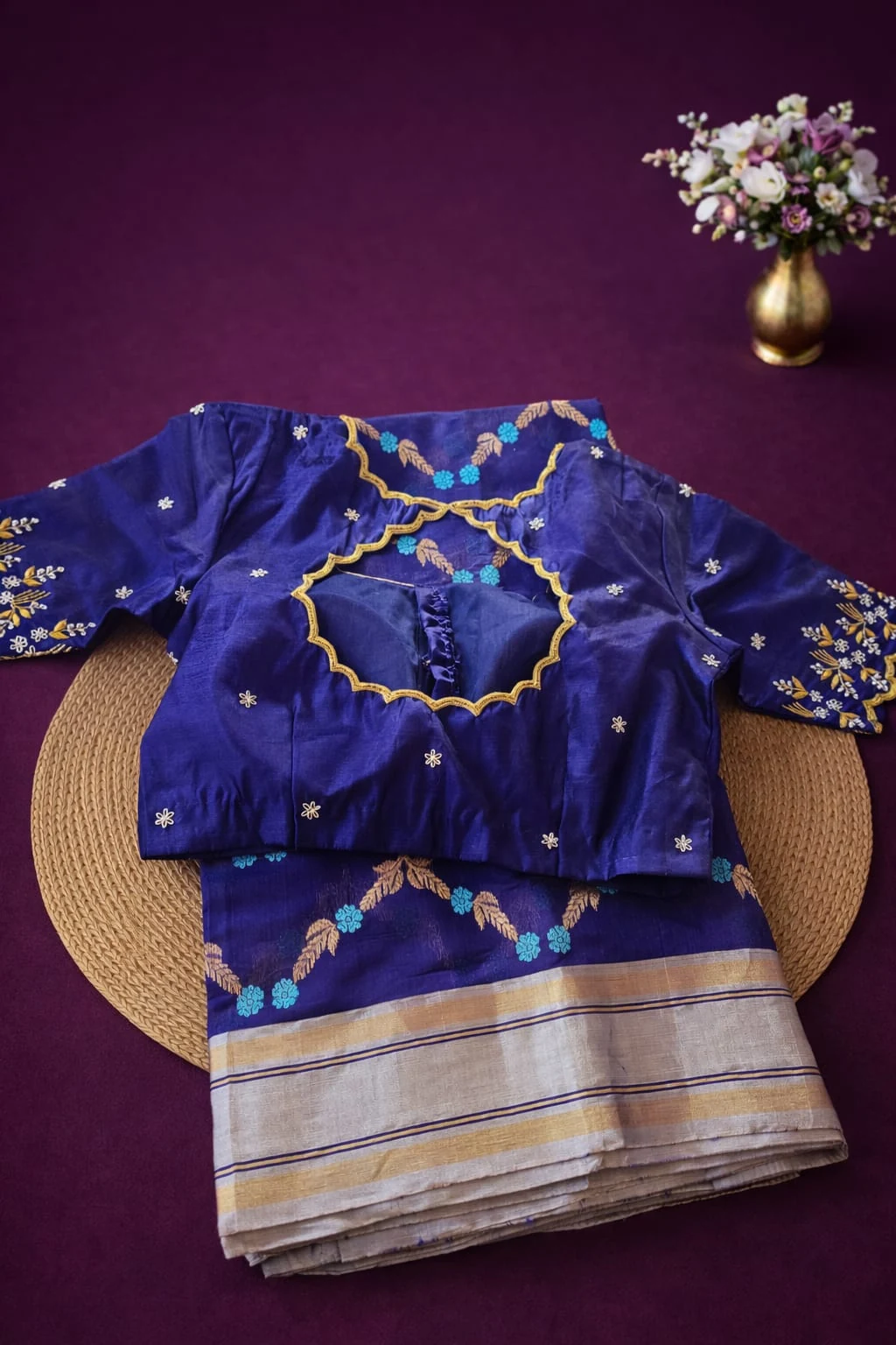Handwoven pure Chanderi Pattu silk saree in silver and blue with floral motifs, paired with an embroidered blue blouse.
