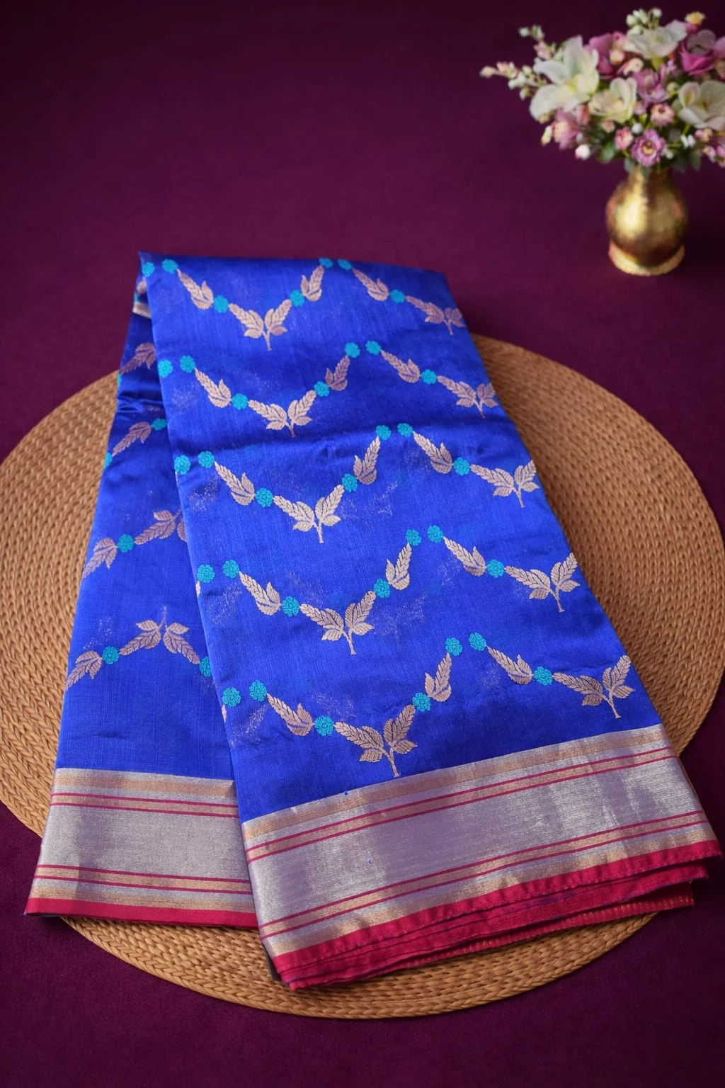Pure Chanderi Pattu silk saree in royal blue with gold zari leaf motifs, silver-red border, handwoven for weddings.