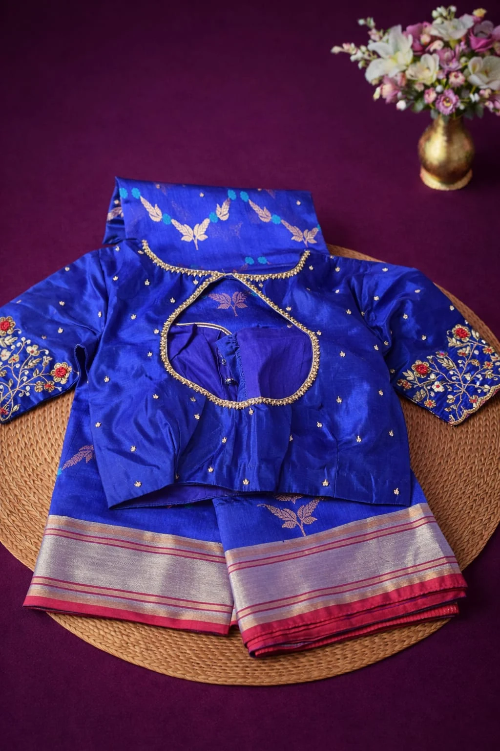 Pure Chanderi Pattu silk saree in royal blue with silver zari border, paired with matching embroidered blouse, displayed flat.